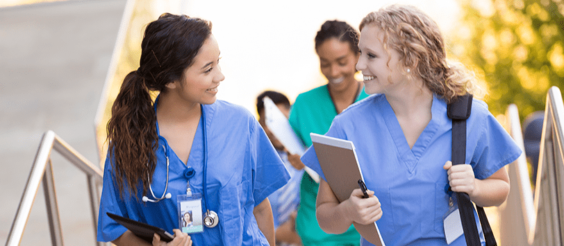 Two female Medical Assistant students in scrubs.